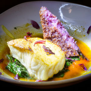 Pan-Seared Sea Bass with Beet Greens and Hibiscus Rice Cake